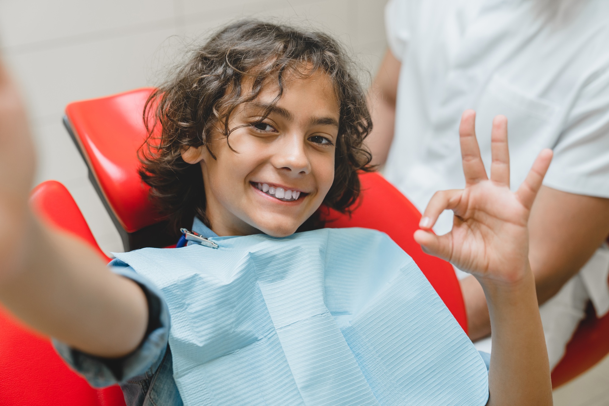 Boy taking selfie with dentist stomatologist, vlogging blogging after teeth braces correction
