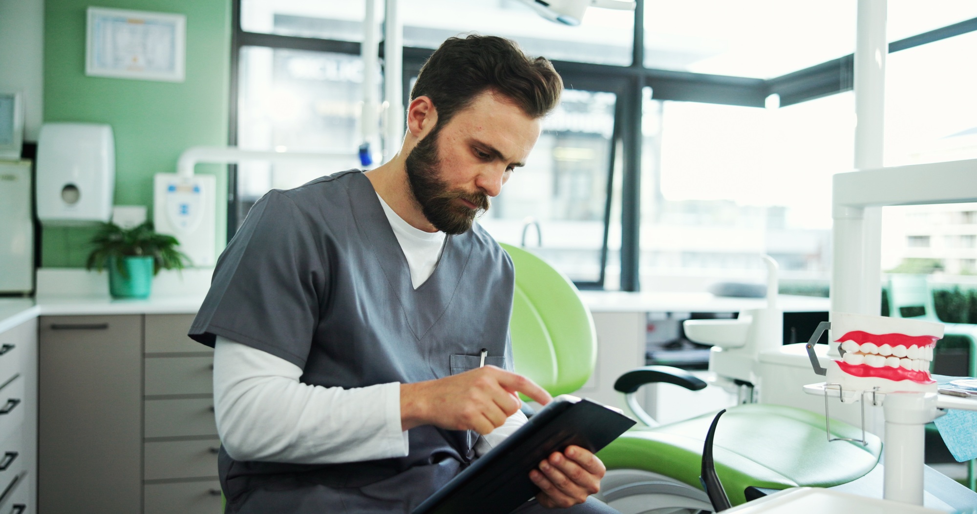 Clinic, office and dentist with tablet for medical service, appointment schedule and research. Heal
