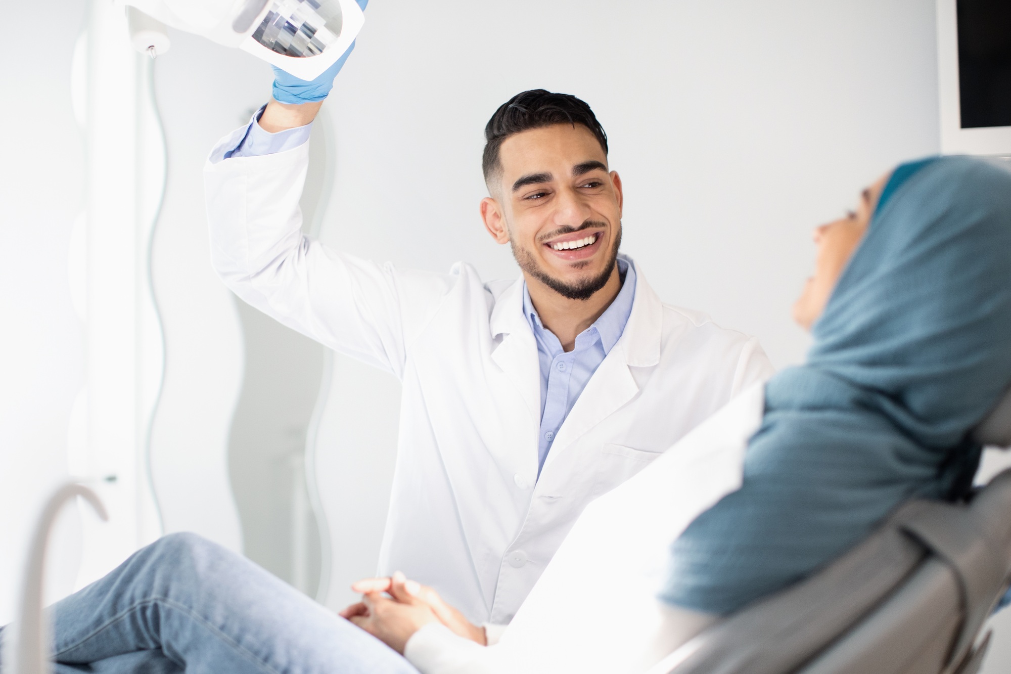 Dental Treatment. Middle Eastern Dentist Doctor Having Checkup With Muslim Female Patient