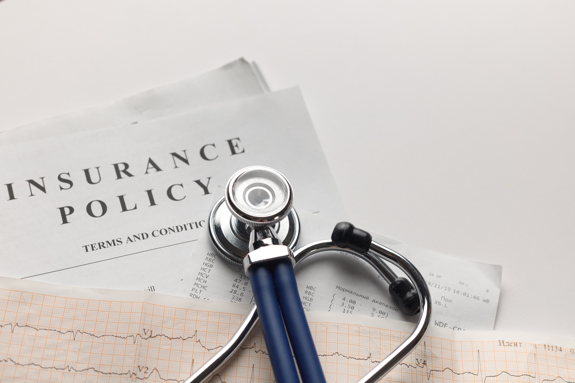 Health insurance. Health insurance form, medical stethoscope, cardiogram chart.