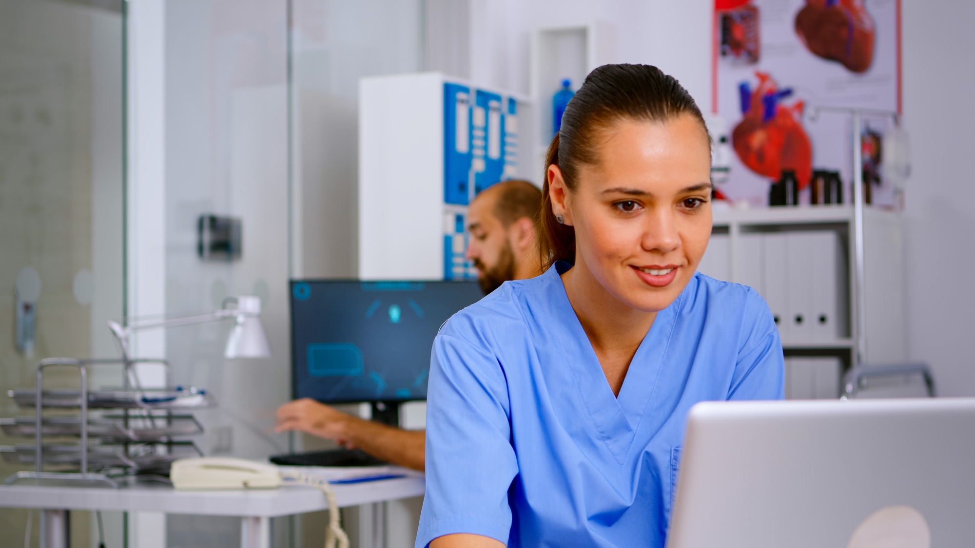 Man medical practitioner answering phone calls and scheduling appointments