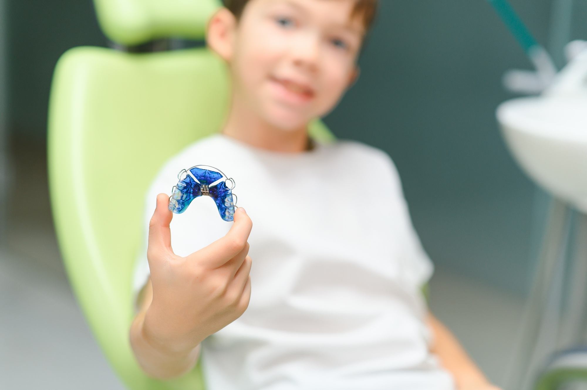 orthodontic plate for correcting an overbite on a boy's hand. close-up