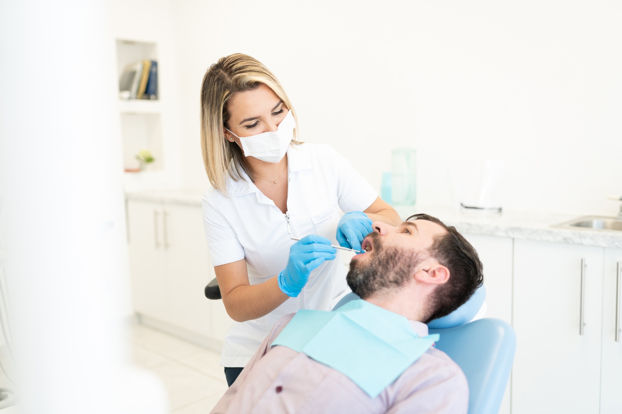 Orthodontist Examining Mid Adult Man
