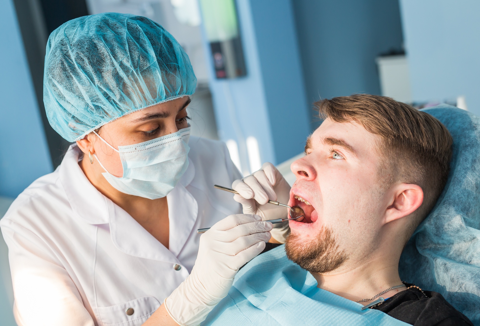 Overview of dental caries prevention. man at the dentist's chair during a dental procedure