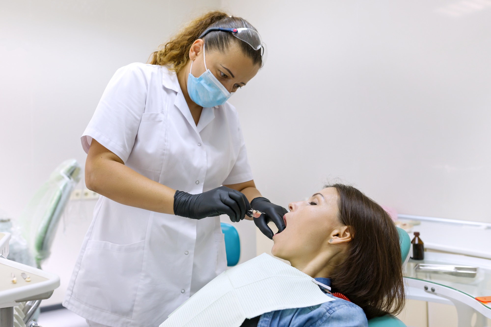 Partial denture, mature woman patient sitting in dental chair