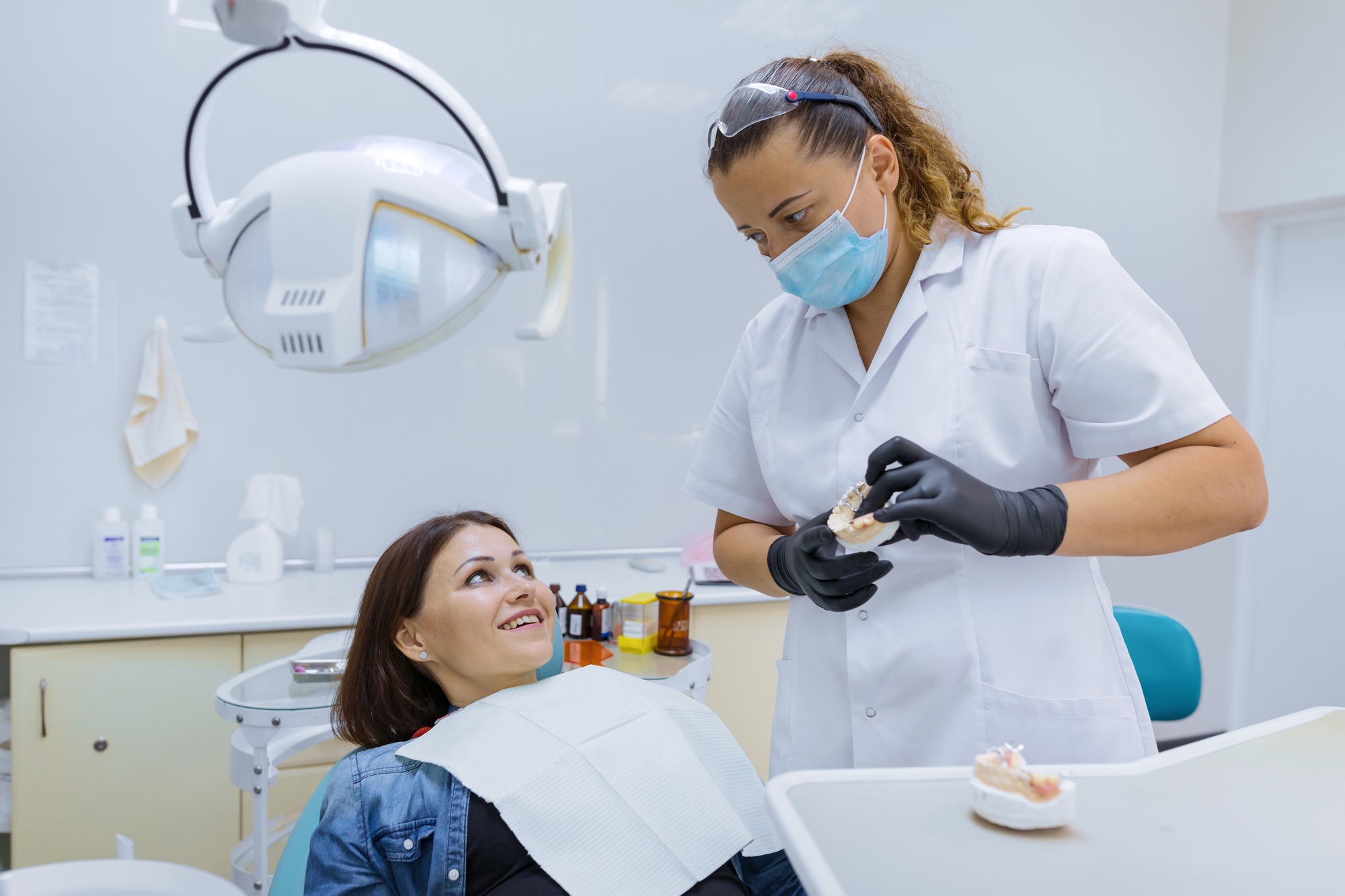 Prosthetics and dental treatment, model of the jaw in the hands of a dentist