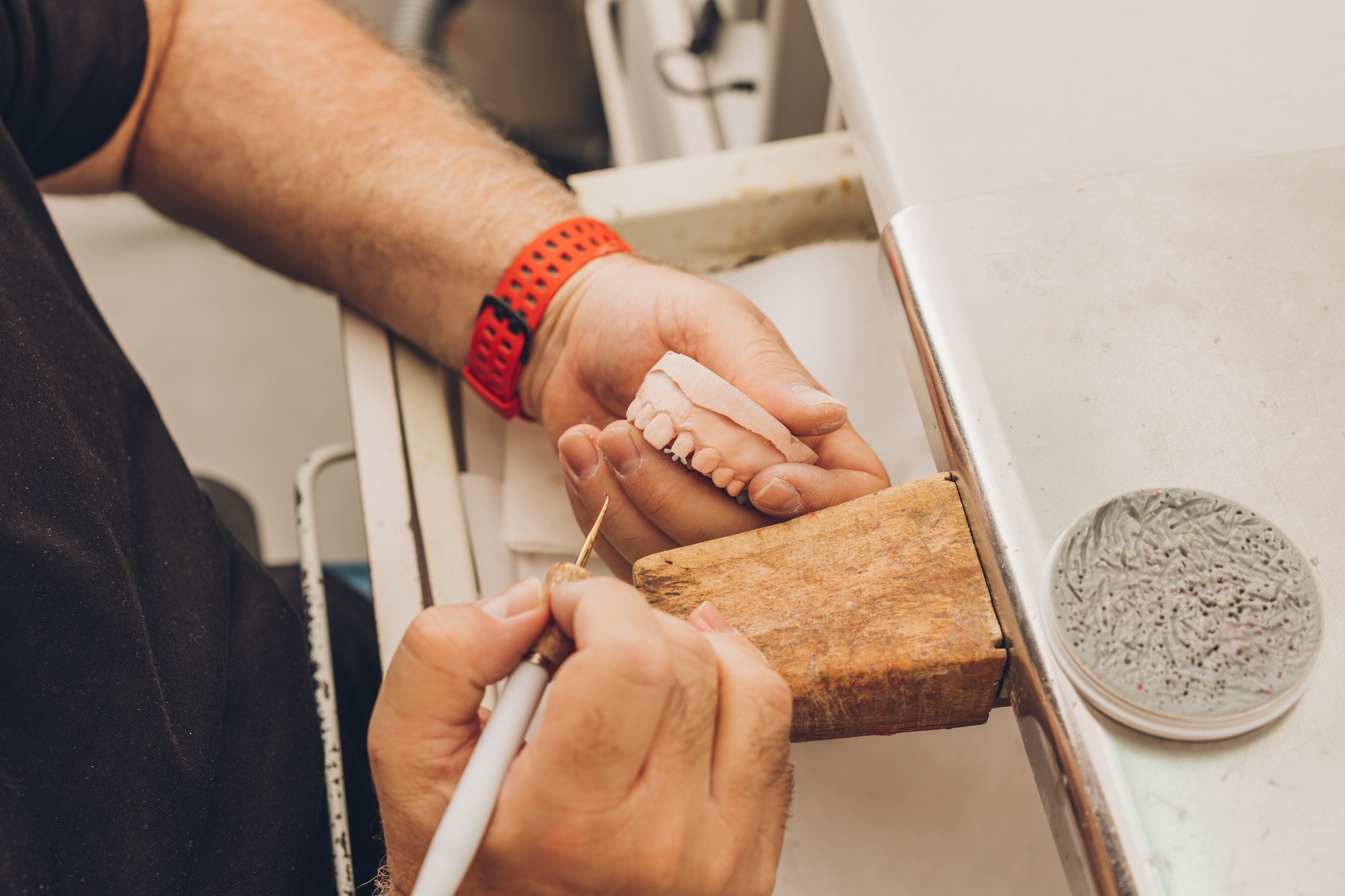 technician mouldingin dental bone ceramics to create porcelain crowns