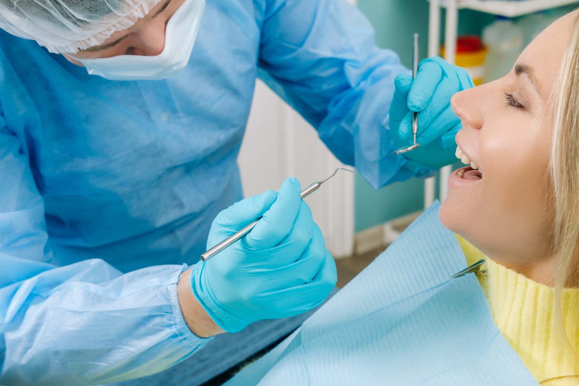 The patient treats her teeth at the dentist in the dental office . Dental fillings