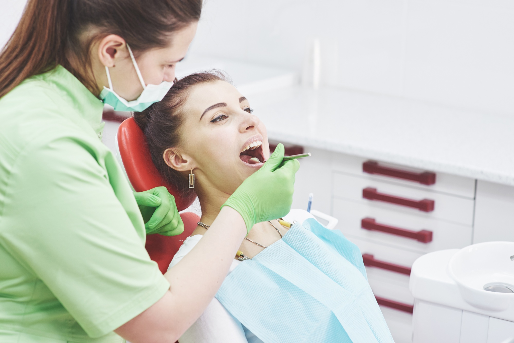 Dentist curing a female patient in the stomatology. Early prevention and oral hygiene concept