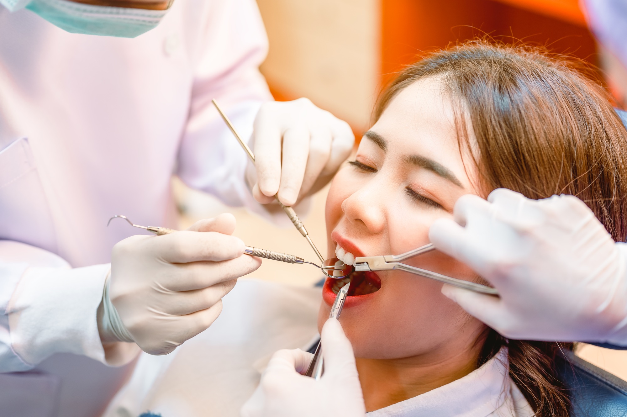 Dentist examining teeth patients in clinic for better dental health and a bright smile.Dentist is ex