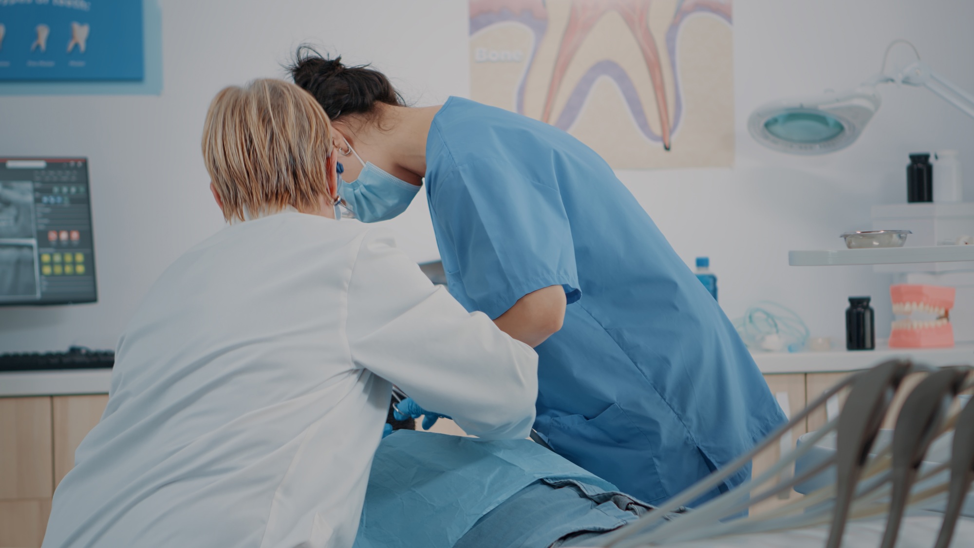 Dentistry team doing teeth extraction on patient with toothache