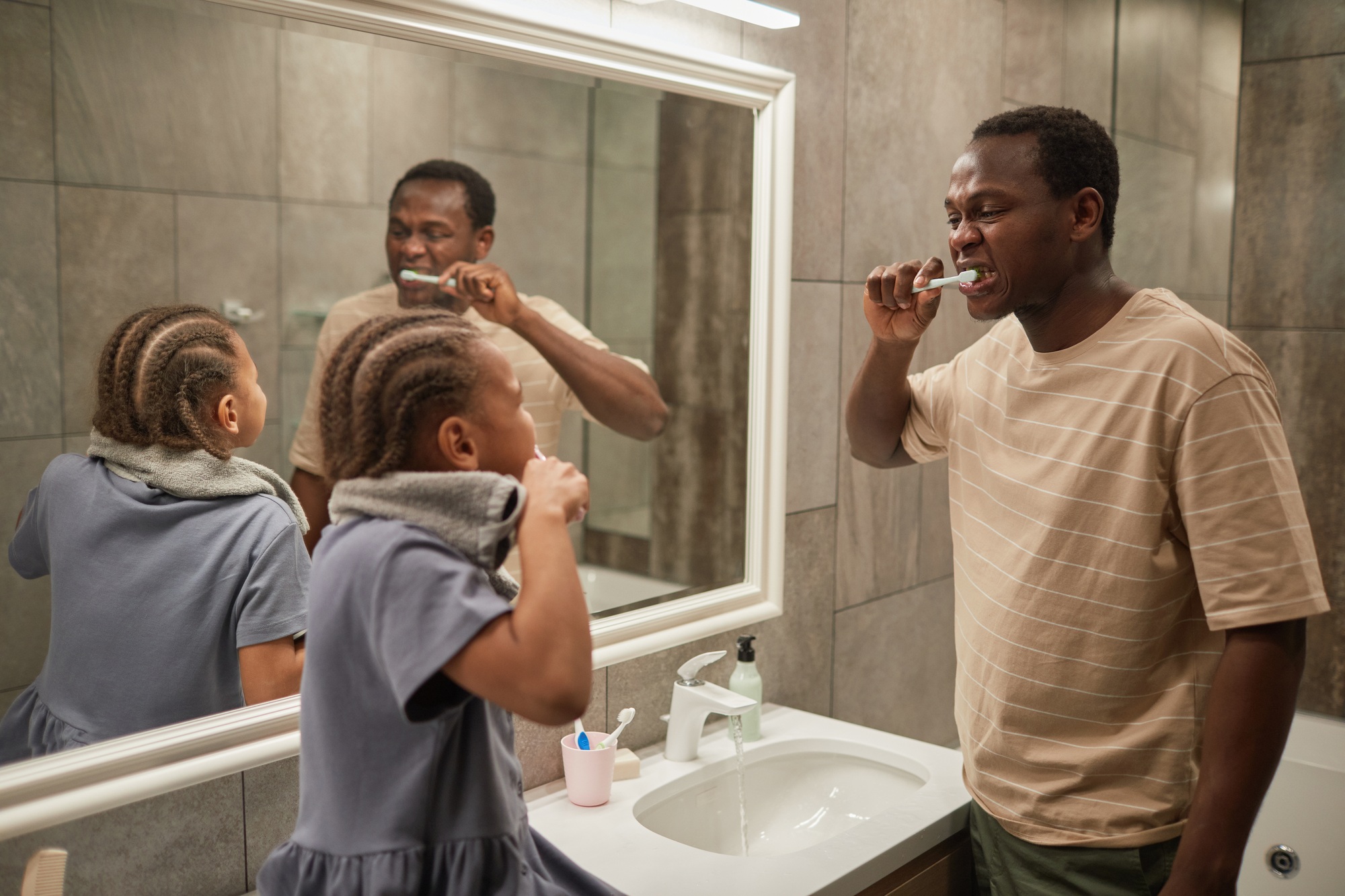 Father and Daughter Brushing Teeth