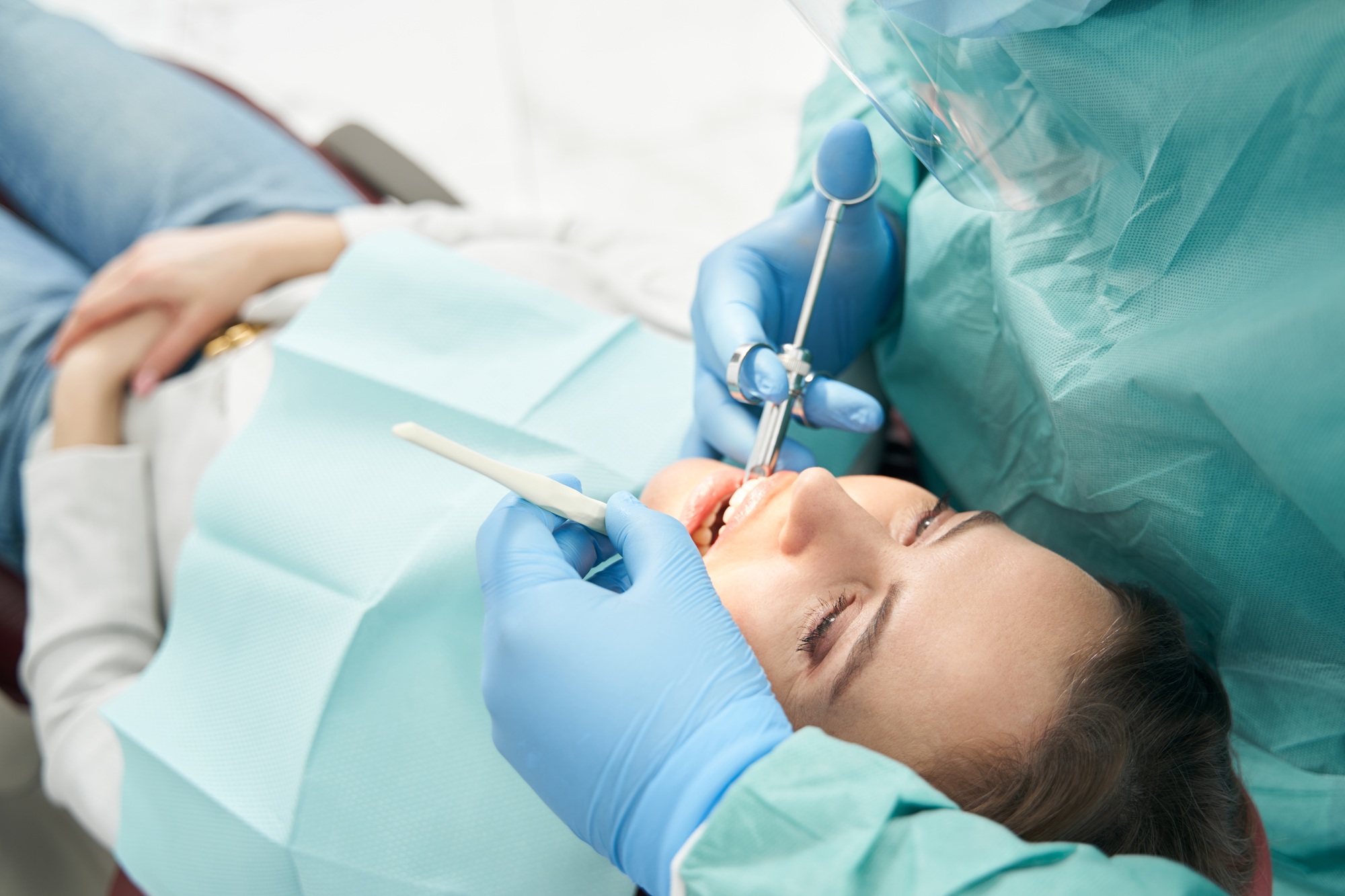 Female patient receiving dental treatment in stomatology clinic