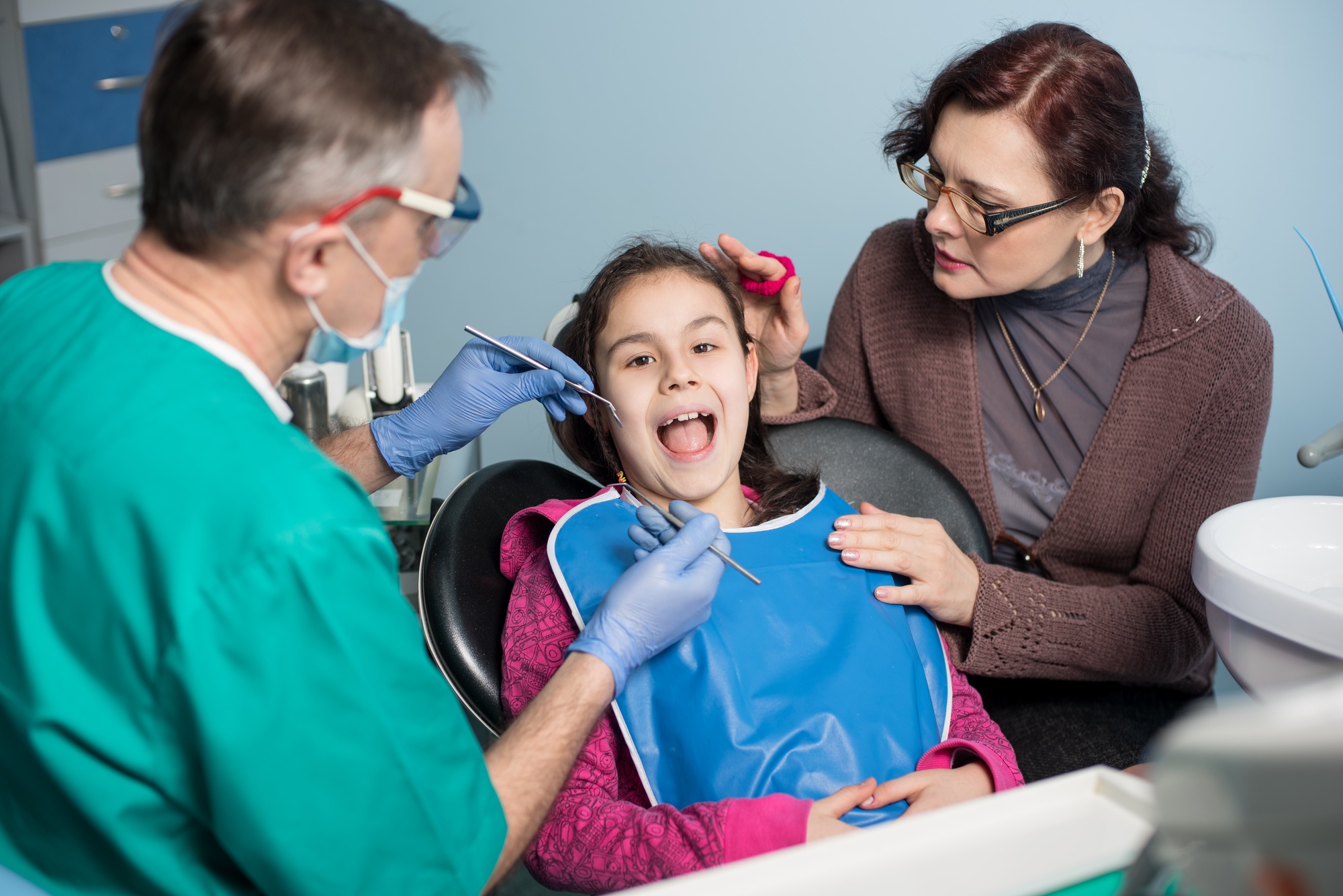 Girl with mother on the first dental visit.