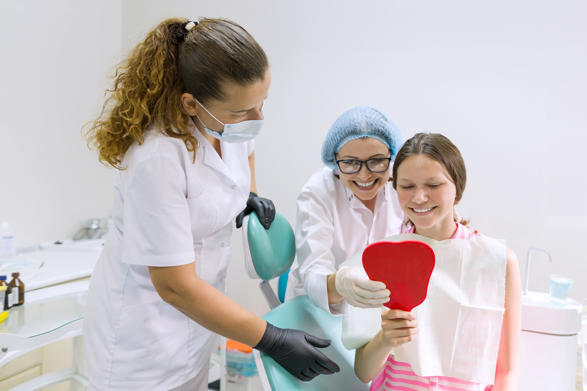 Happy teen girl in dental chair. Medicine, dentistry and healthcare concept