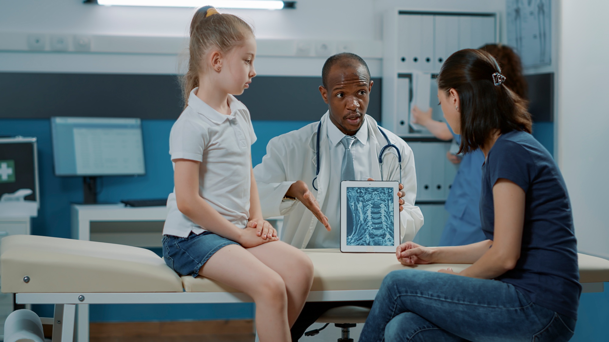 Male doctor showing x ray scan results on digital tablet