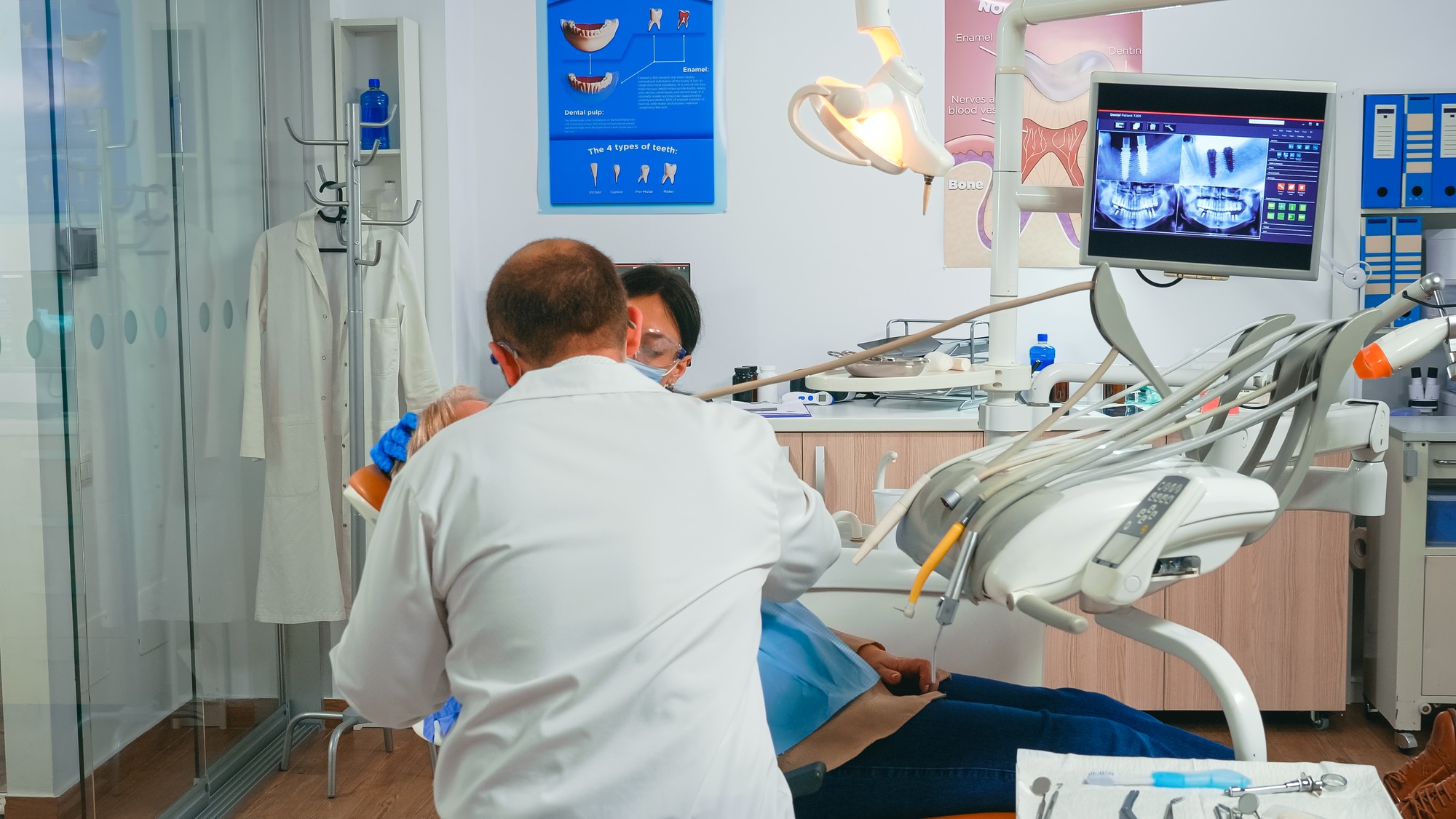 Oral surgeon performing surgery installing implant